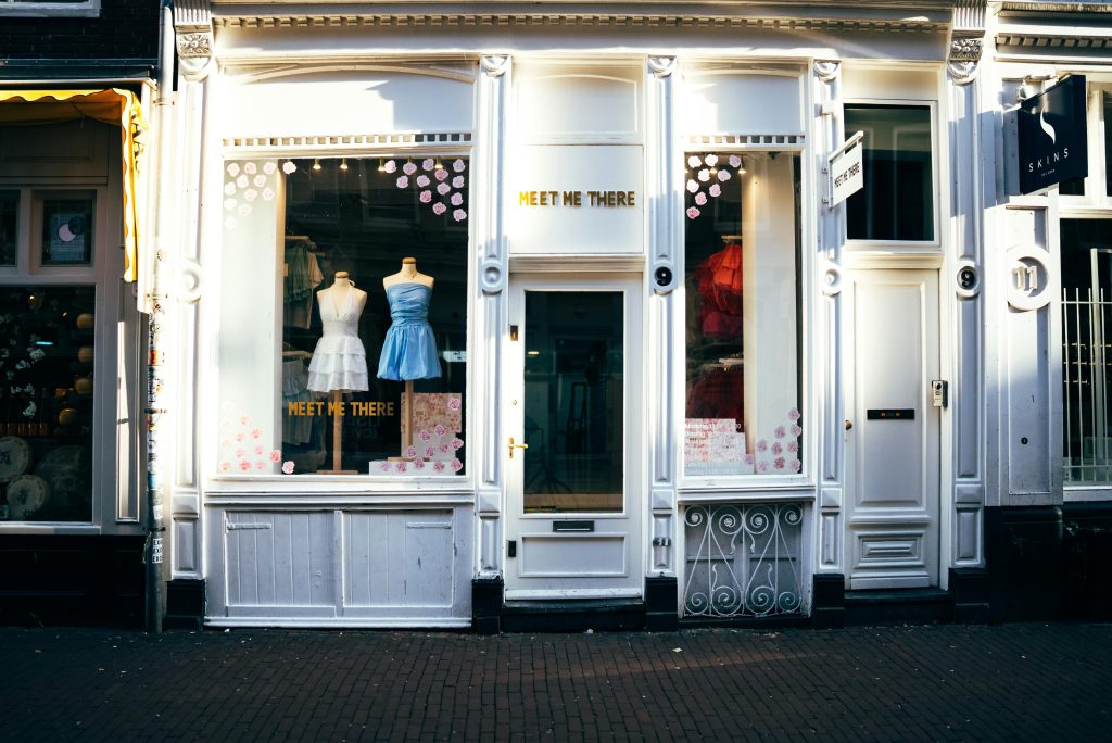 Elegant storefront with mannequins in stylish dresses, showcasing boutique charm.